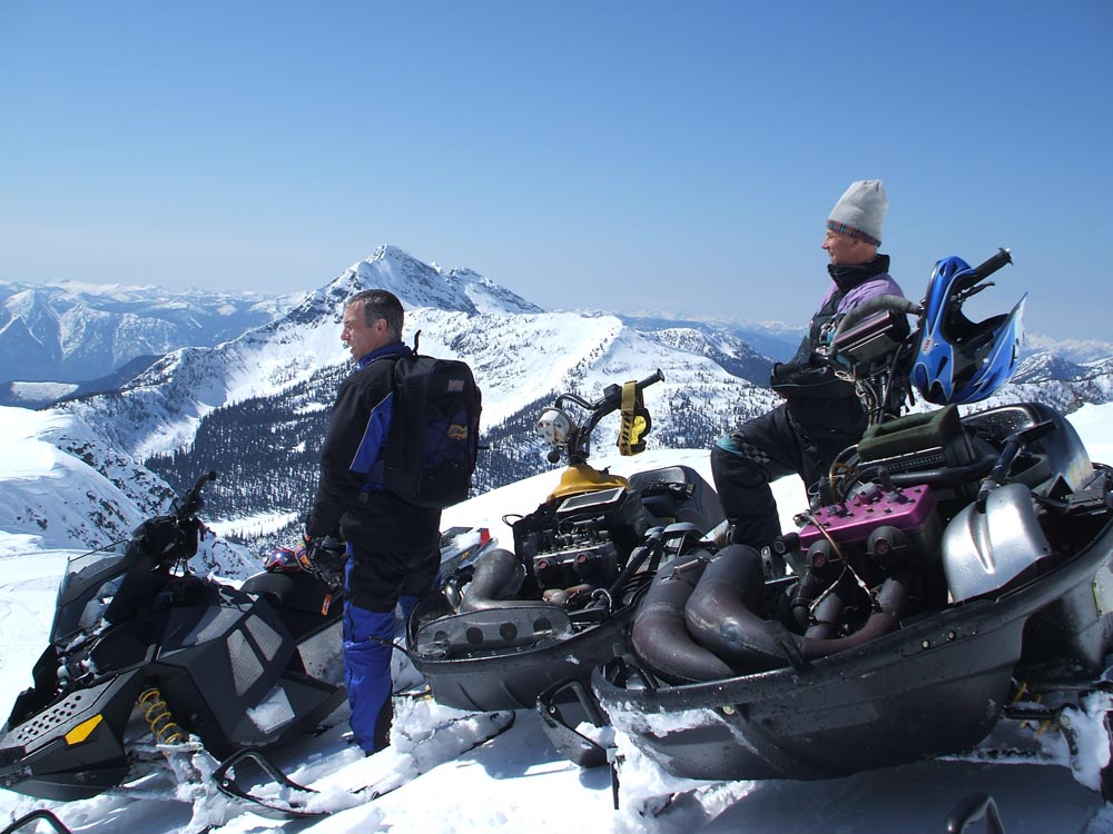 Clayton and Dan with Sleds - A nostalgic image showcasing Clayton and Dan with snowmobiles in the British Columbian mountains March 2008 at Hi-Torque Rollers