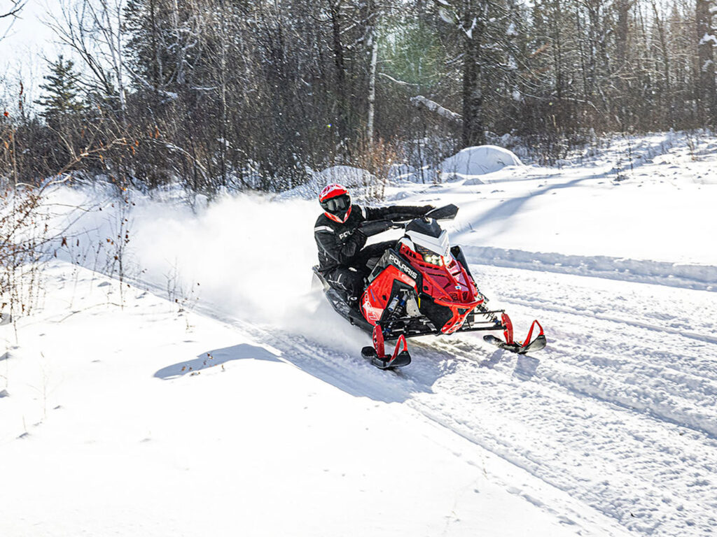 Polaris Snowmobile Adventure - A captivating image featuring a Polaris snowmobile navigating snowy terrain highlighting Hi-Torque Rollers for the Polaris secondary CVT clutch.